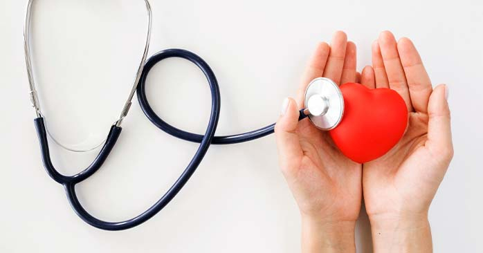 Person holding heart shape with stethoscope